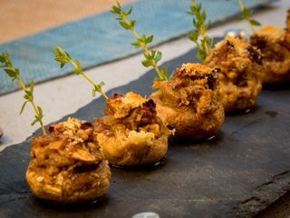 Crispy Button Mushrooms with Herbs & Melted Cheese on a granite serving platter.