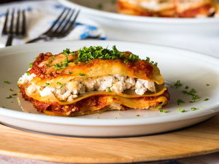 Piece of lasagna on a plate.