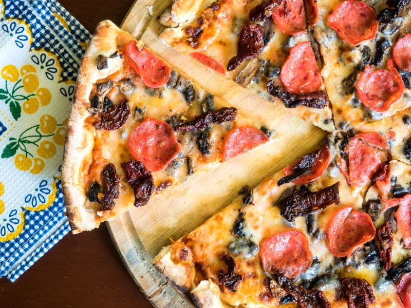 Pizza on a serving board.