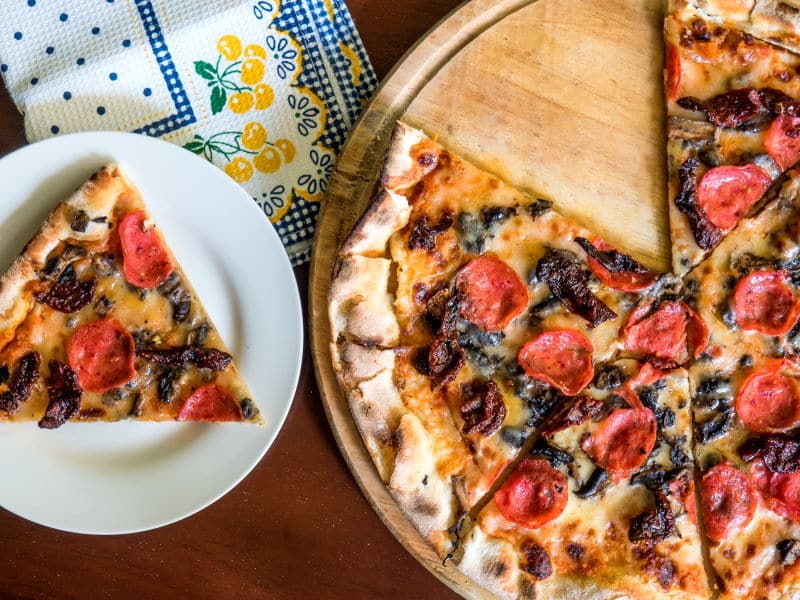 Pizza on a serving board.