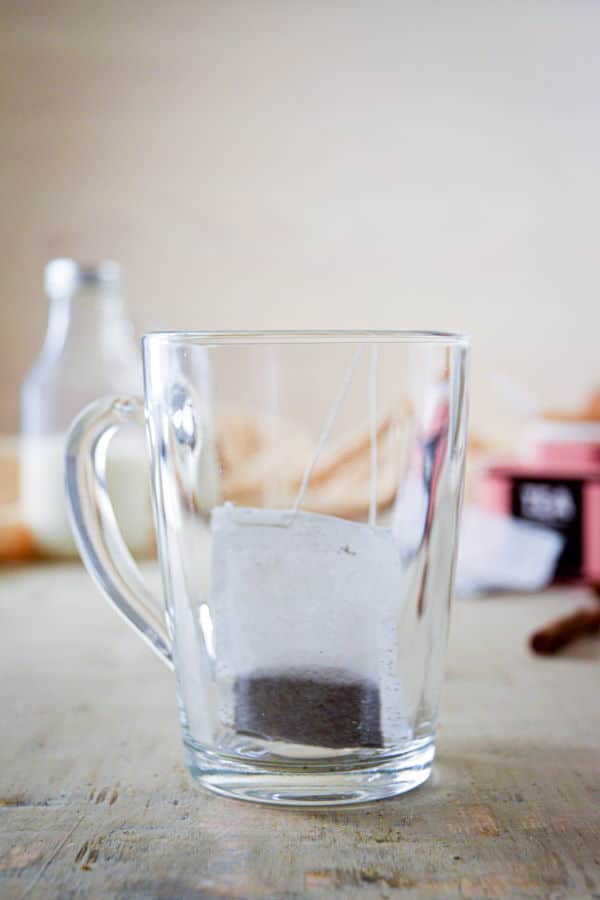 A clear glass mug with earl grey tea bag.