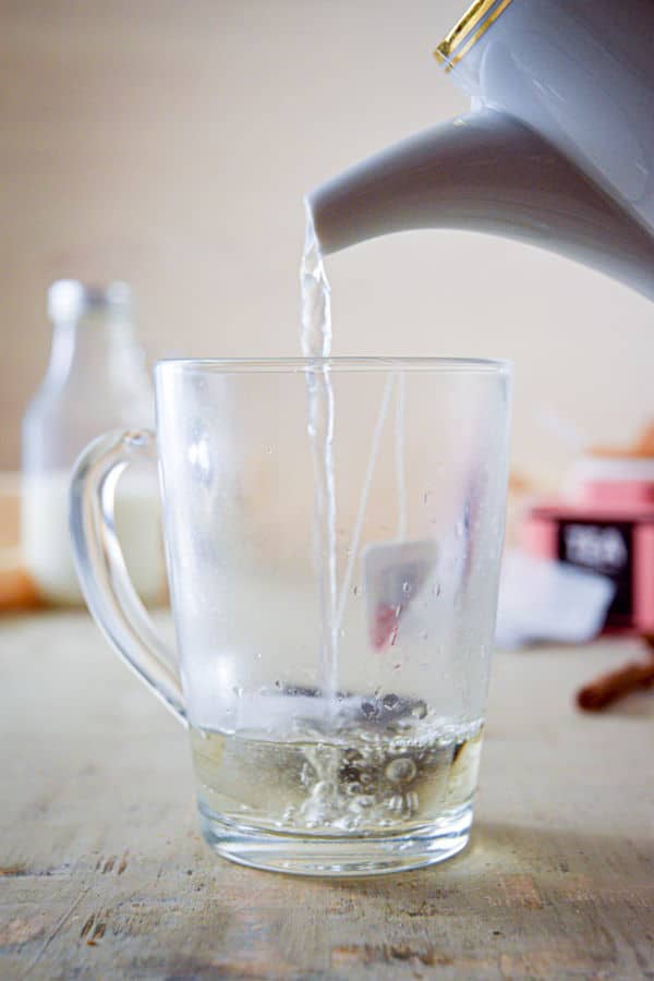 Earl grey tea steeped in a clear glass mug.