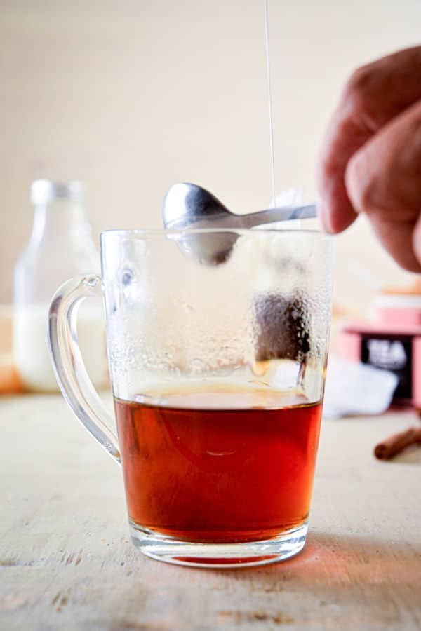 Earl grey tea steeped in a clear glass mug.
