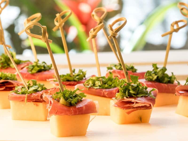 Melon & Prosciutto Skewers Over Greens Mix Melong, prosciutto and greens mini skewers.