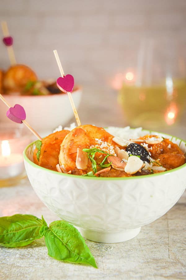 Valentines Shrimp Curry with Basmati Rice_4 Shrimp curry in a white bowl with pink heart toothpicks, basil on the side.