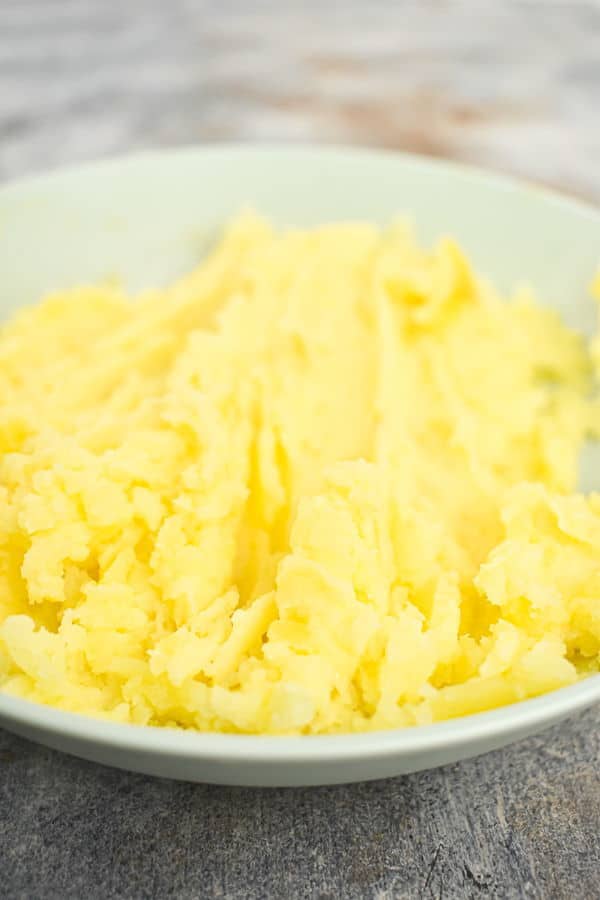 Potatoes, cheese and butter on a plate.