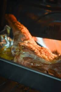 Lamb shoulder cooked in a roasting pan.
