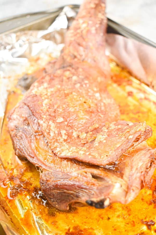 Lamb shoulder cooked in a roasting pan.