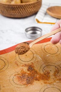 Cajun spices sprinkled over a greased silicone mat.