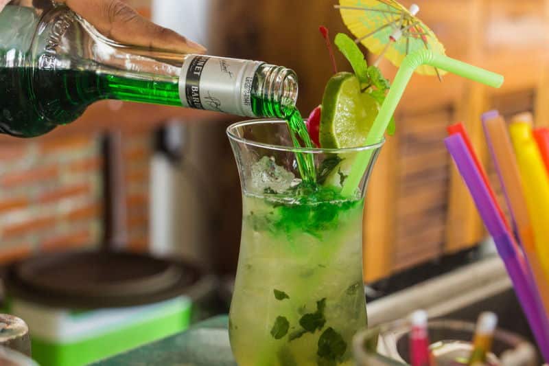 Green cocktail with umbrella.