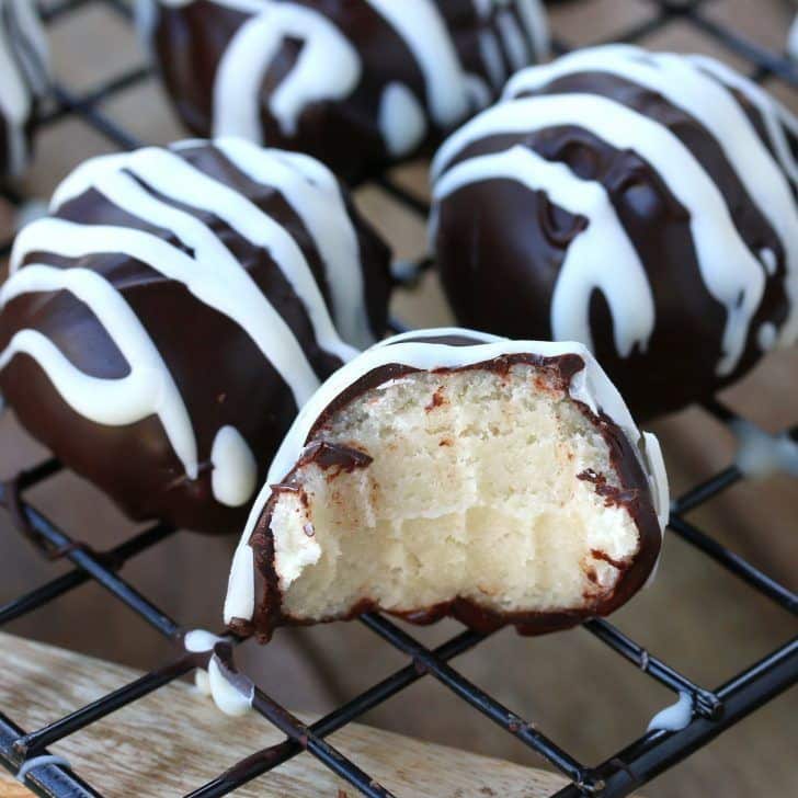 Chocolate marzipan truffles with white chocolate drizzle.