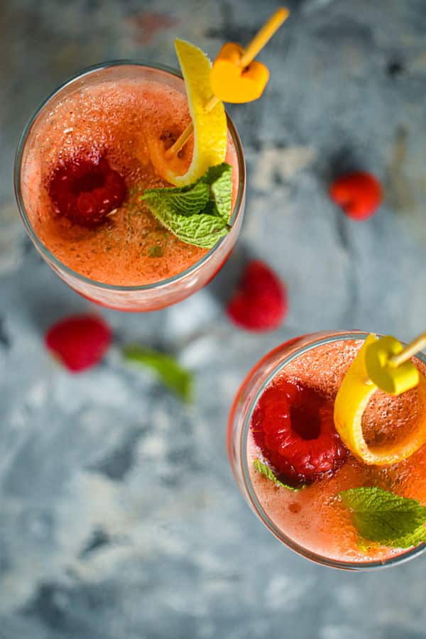 DSC_2520 Raspberry twist cocktail with mint and lemon twist in a champagne flute.