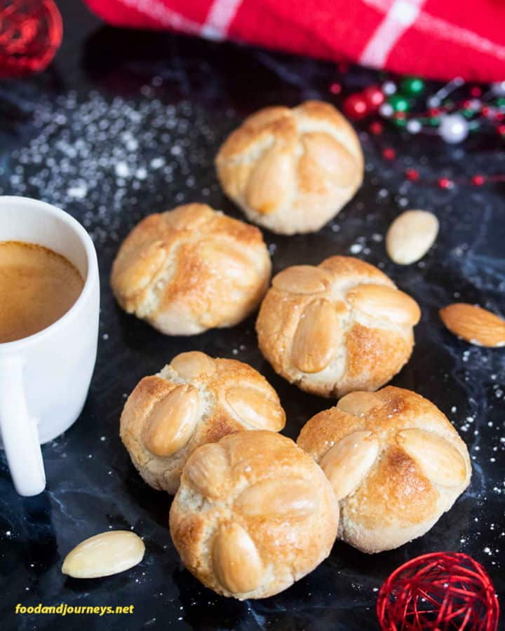 Marzipan bites with almonds and a coffee mug.