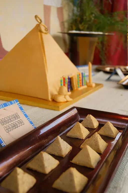 Marzipan pyramids on platter, pyramid decoration in background.