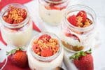 Raspberry cheesecake in mini dessert jars.