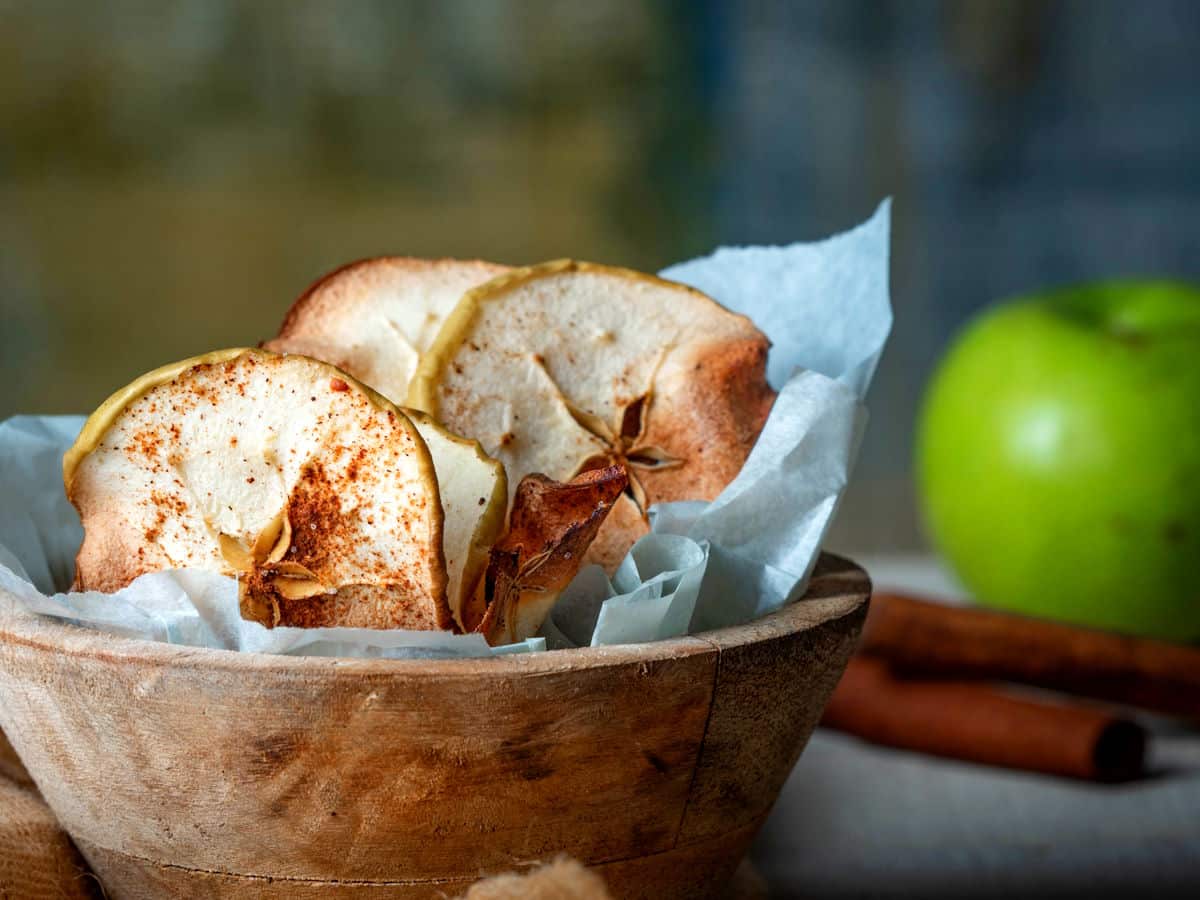 Cinnamon Apple Chips in a wooden bowl.