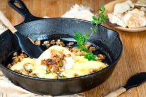 Baked brie in cast iron pan with mushrooms, walnuts and honey.
