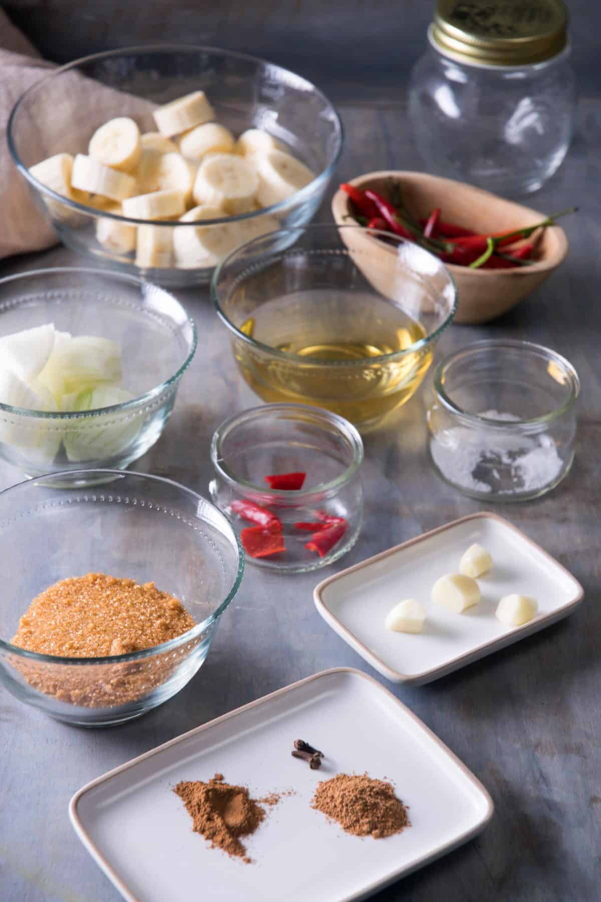 Banana ketchup ingredients prepped on concrete style background.