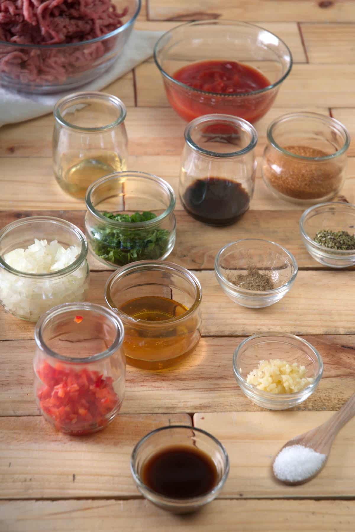 Bison meatball ingredients prepped on wooden background.