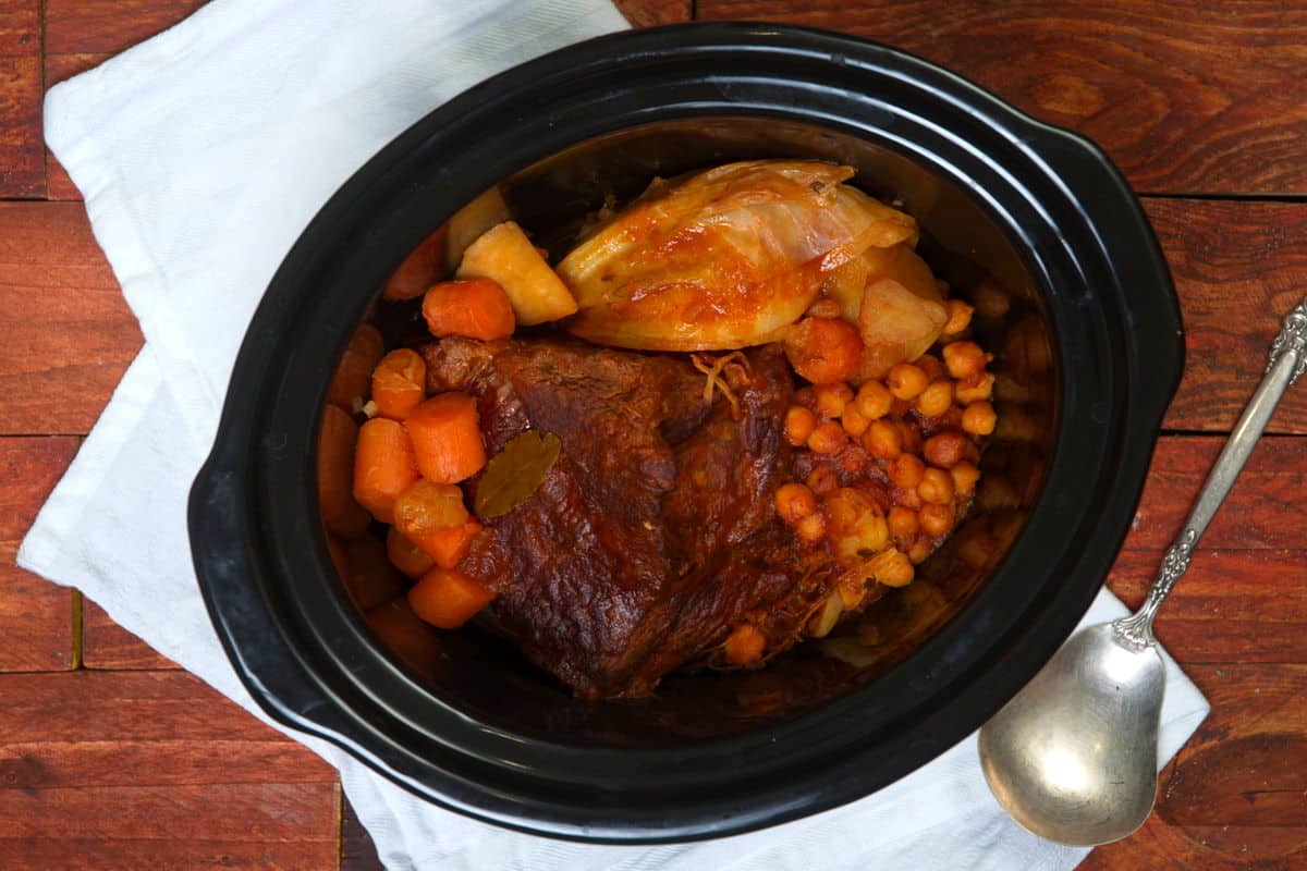 Bison pot roast with vegetables in slow cooker.