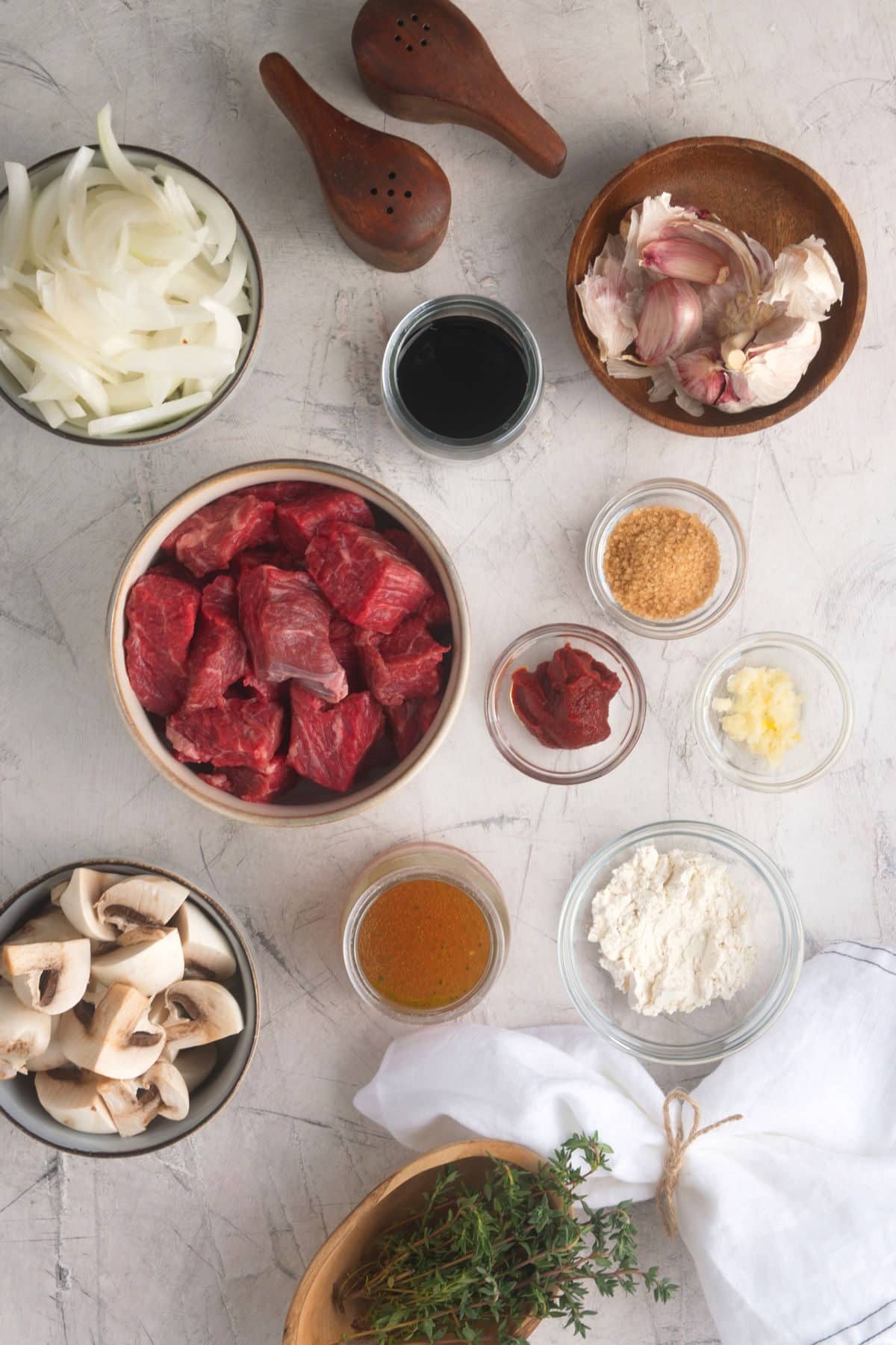 Bison stew ingredients prepped on marble background.