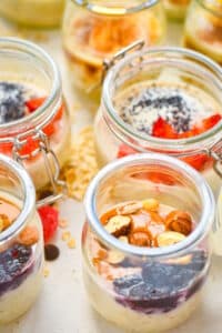Porridge shots with peanut butter, jelly and hazelnuts, strawberries and poppy seeds.