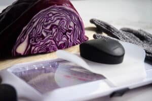 Red cabbage, a mandolin and finger guard.