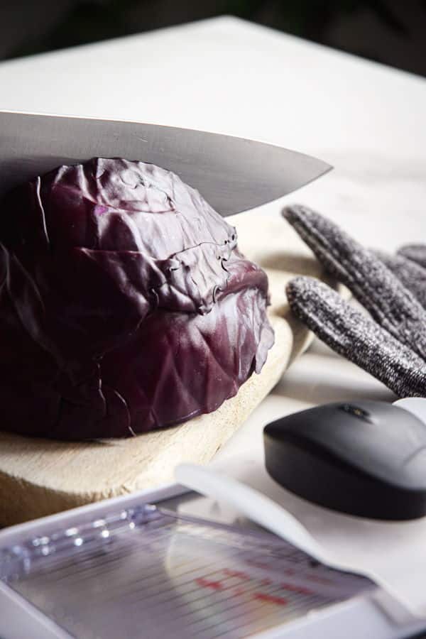 Red cabbage, a mandolin and finger guard.