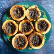 Canadian butter tarts on Christmas themed plate.