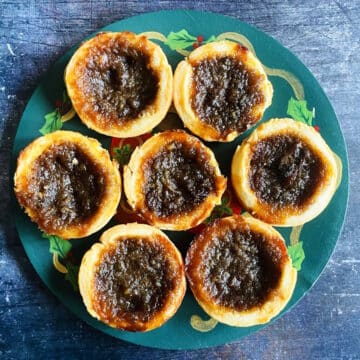 Canadian butter tarts on Christmas themed plate.