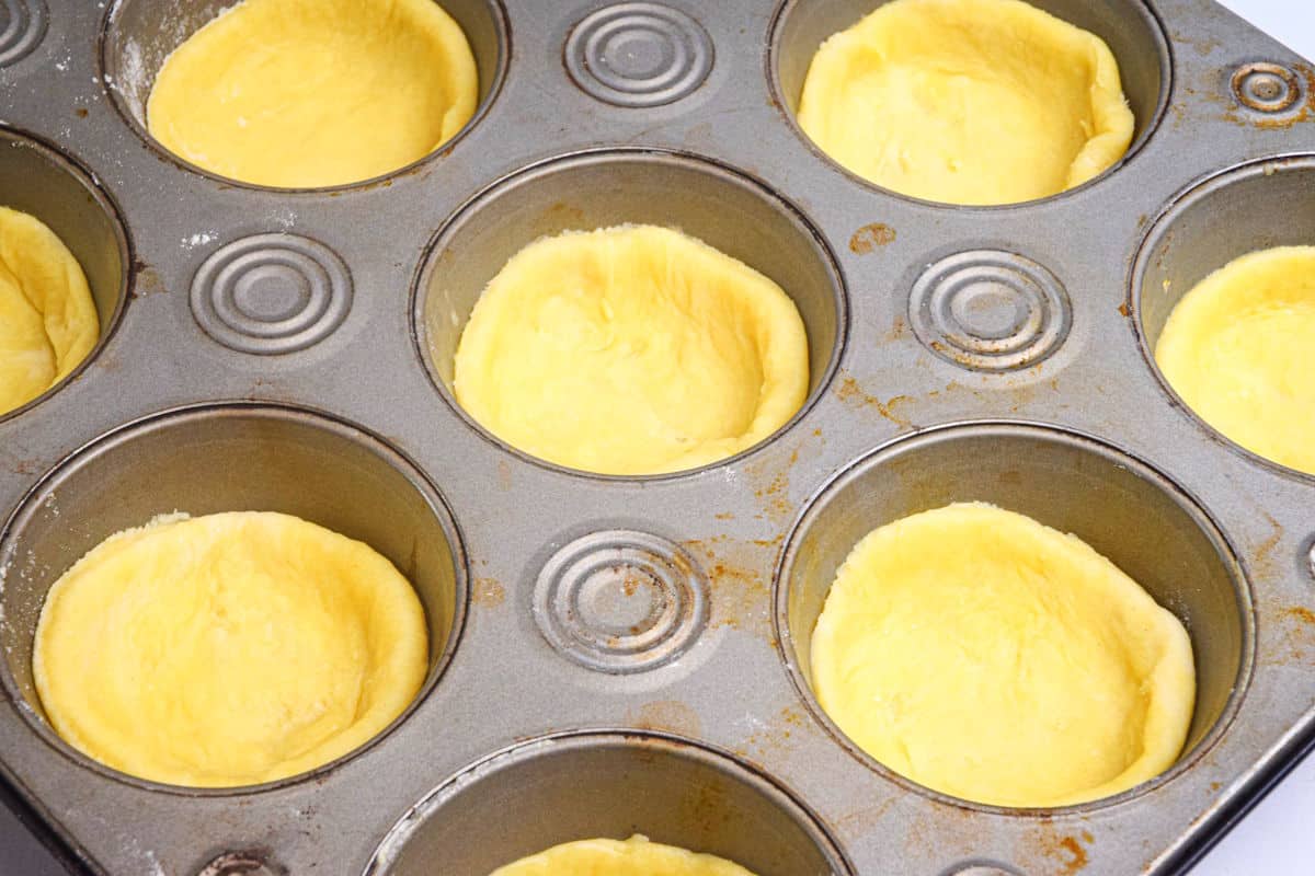 Butter tart pastry in muffin tin.