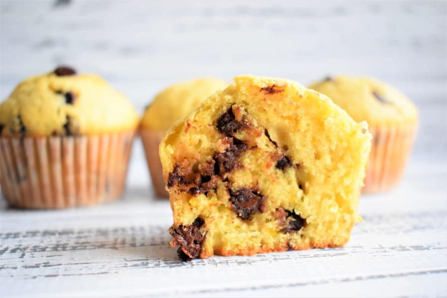 Chocolate Chip Orange Zest Muffins on white wooden background.