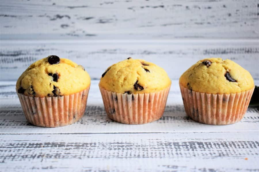 Chocolate Chip Orange Zest Muffins on white wooden background.