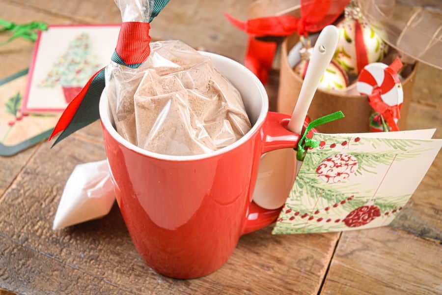 Chocolate cake ingredients in a red mug with Christmas decorations.