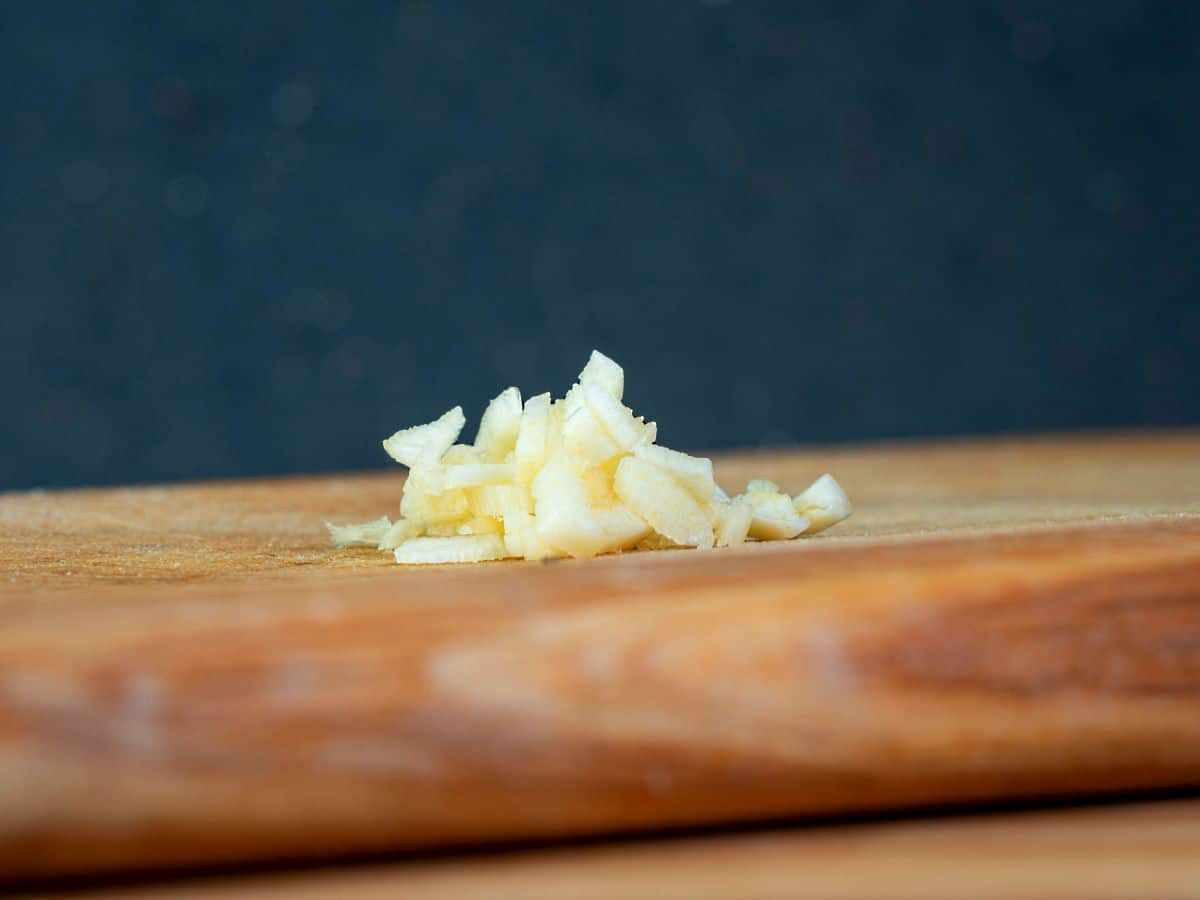 Chopped garlic on cutting board.