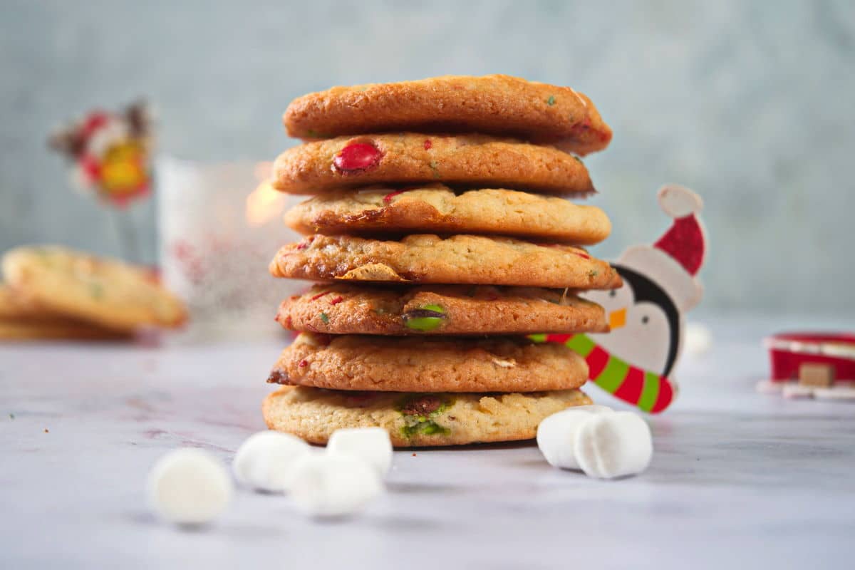 Christmas cookies stacked on light background.