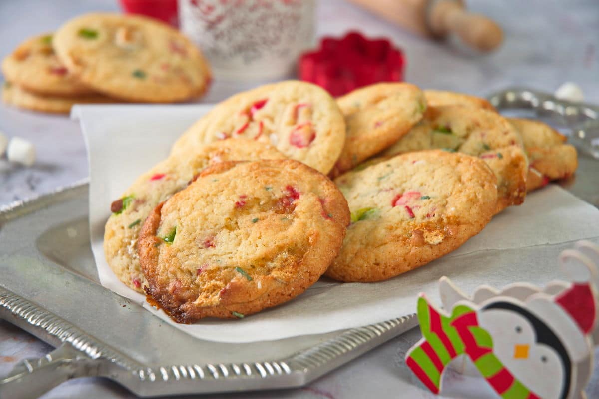 Christmas cookies on a serving tray with Christmas decorations.