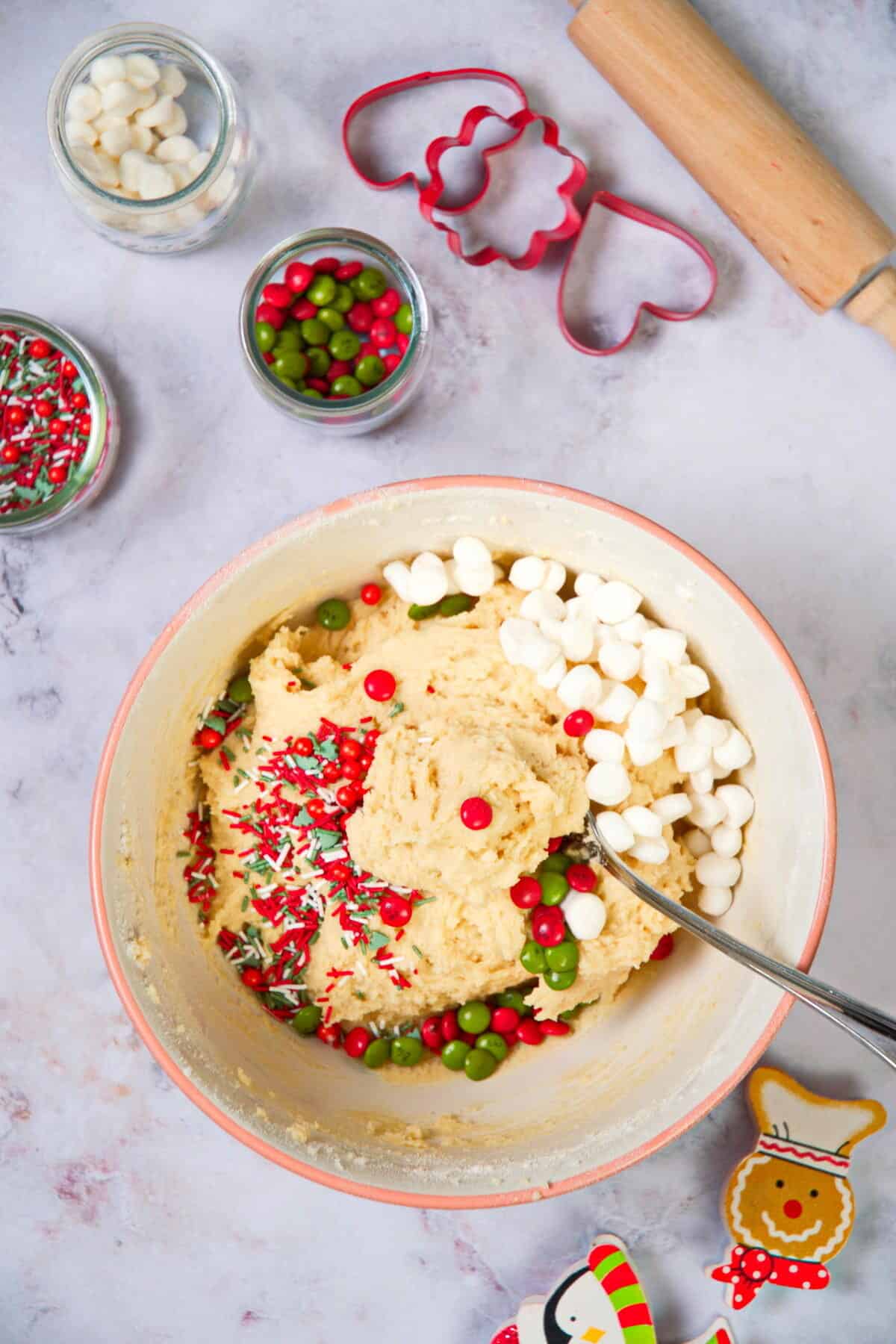 Christmas cookie dough in a bowl with a spoon.