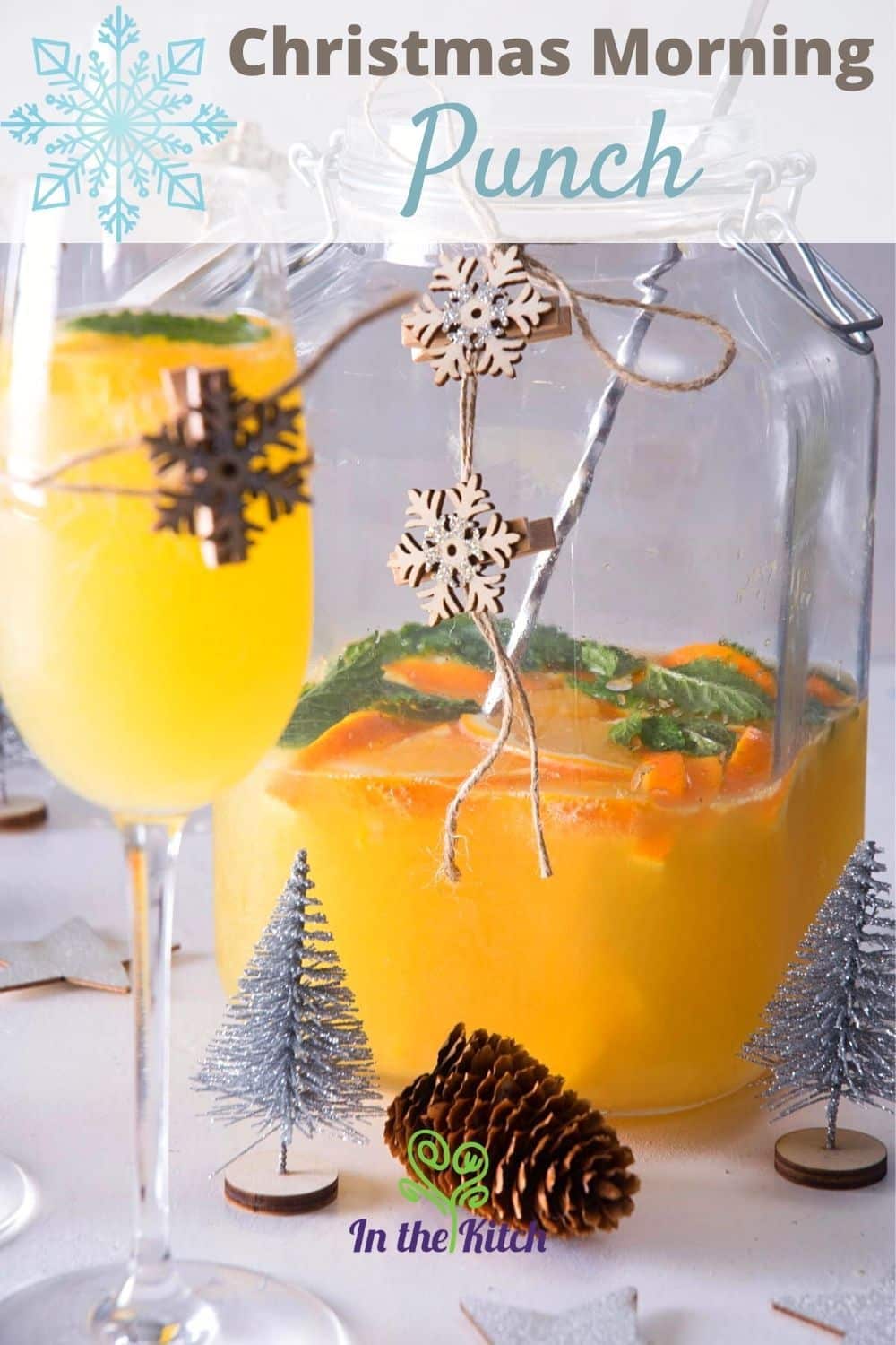 Christmas punch in a pitcher and champagne glass with Christmas decorations.