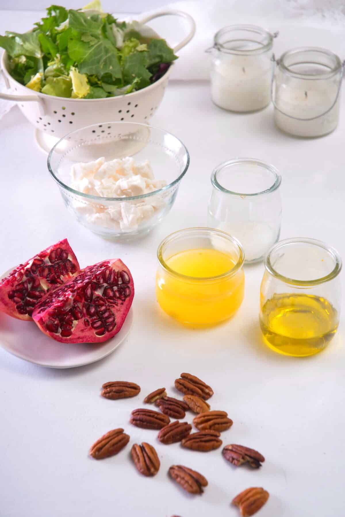 Christmas wreath salad ingredients prepped on light background with white candles in the back.