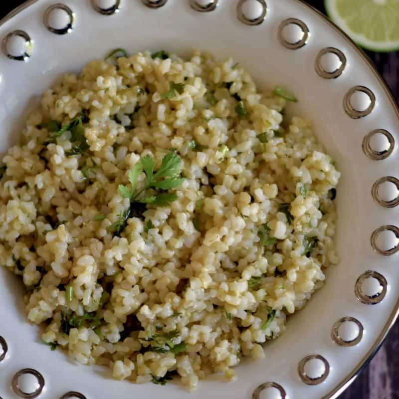 Brown rice with cilantro in white bowl.