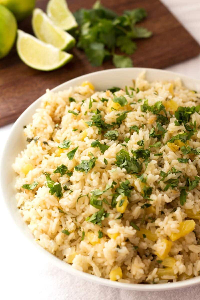 Cilantro rice with pineapple in a white bowl.