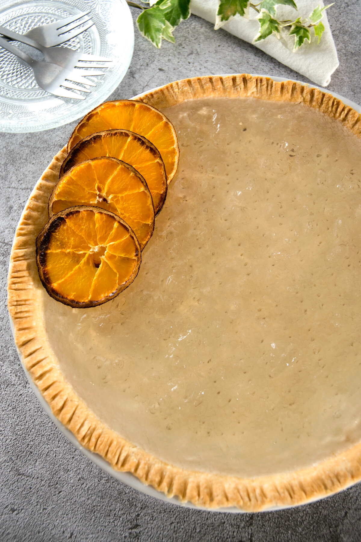 Clear pumpkin pie with dehydrated orange slices.