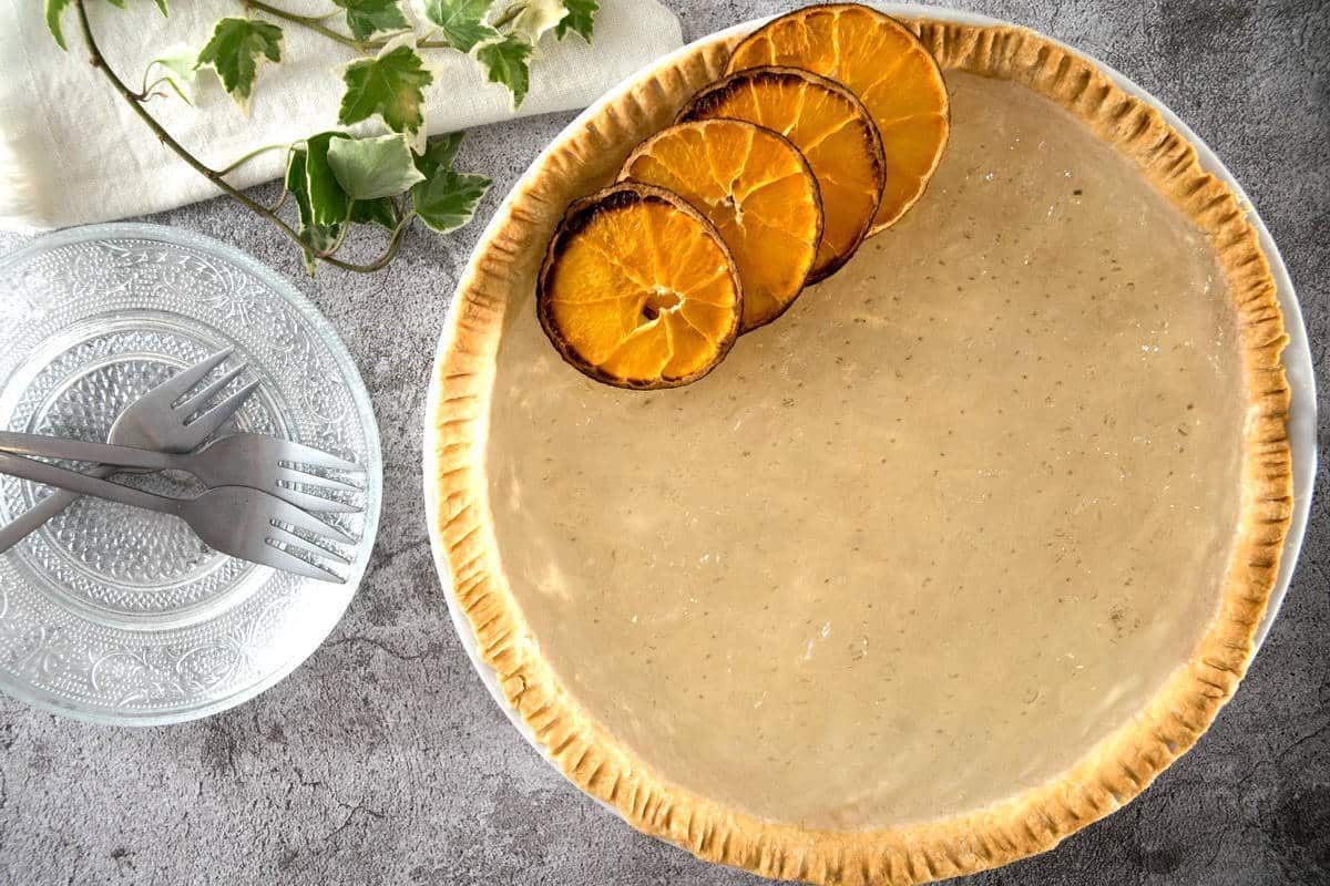 Clear pumpkin pie with dehydrated orange slices.