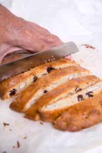 Cranberry biscotti sliced with a serrated knife.