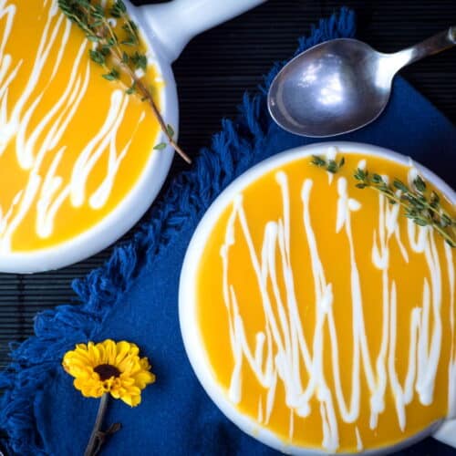 Pumpkin soup in white porcelain soup bowls.