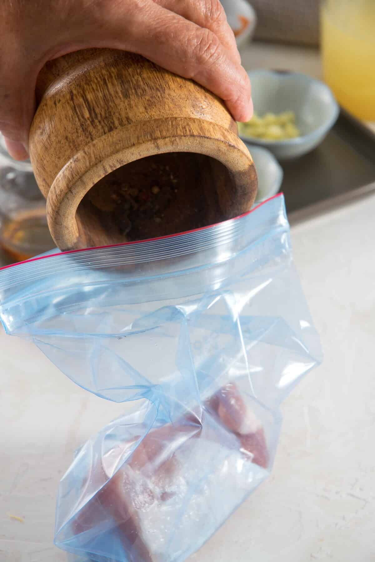 Spices in a mortar and a zip-top bag.