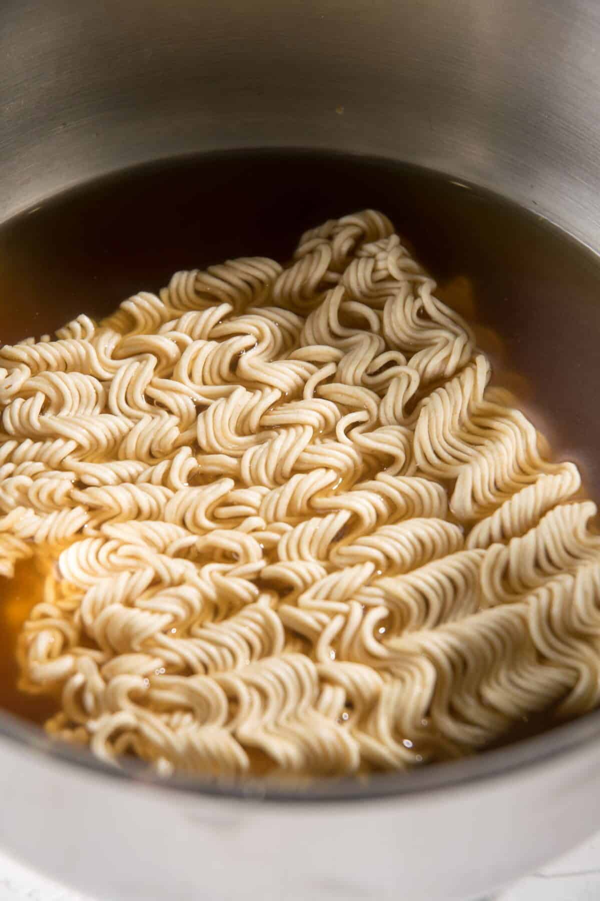 Instant ramen noodles in a pot.