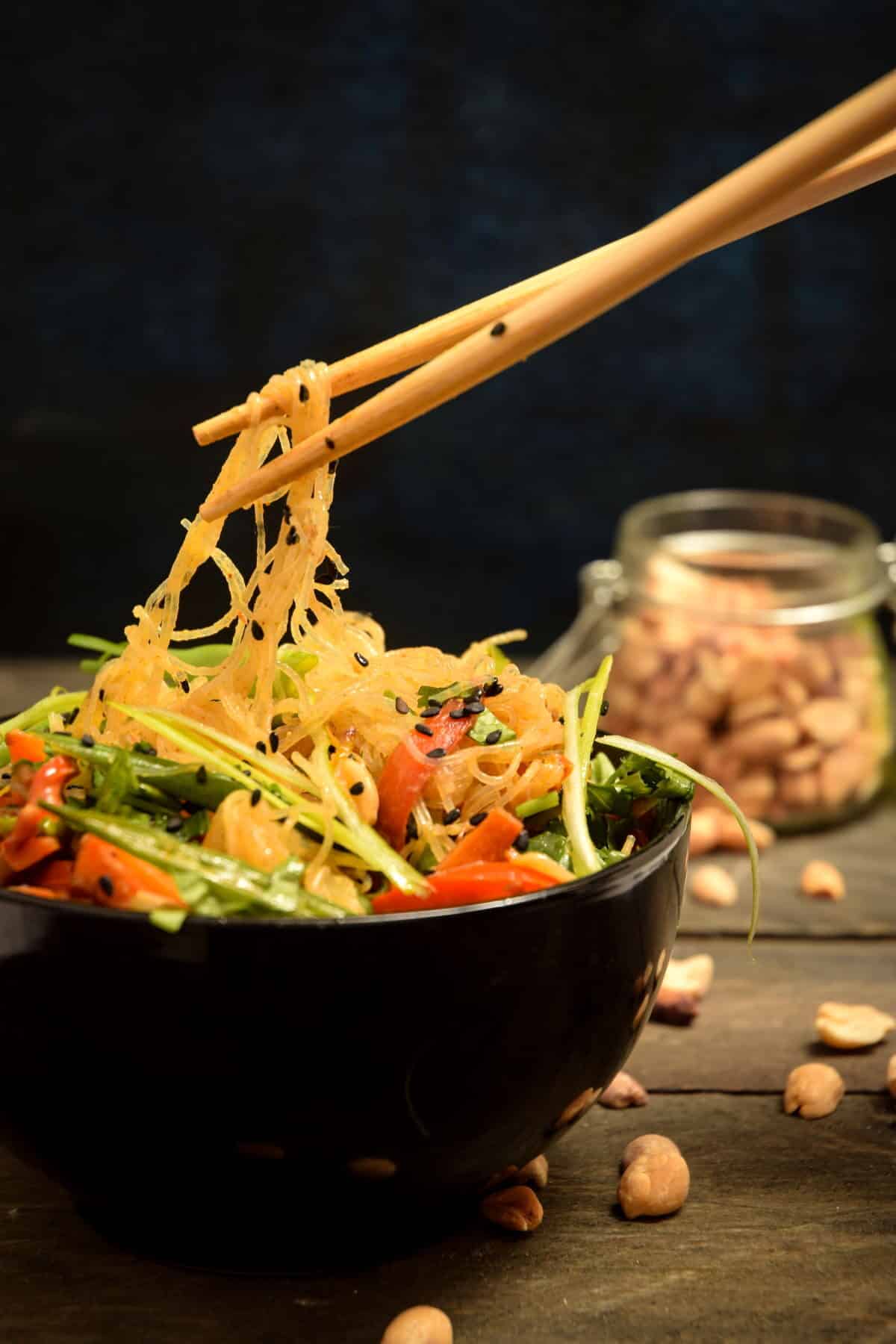 Vegan Pad Thai in a black bowl with chopsticks.