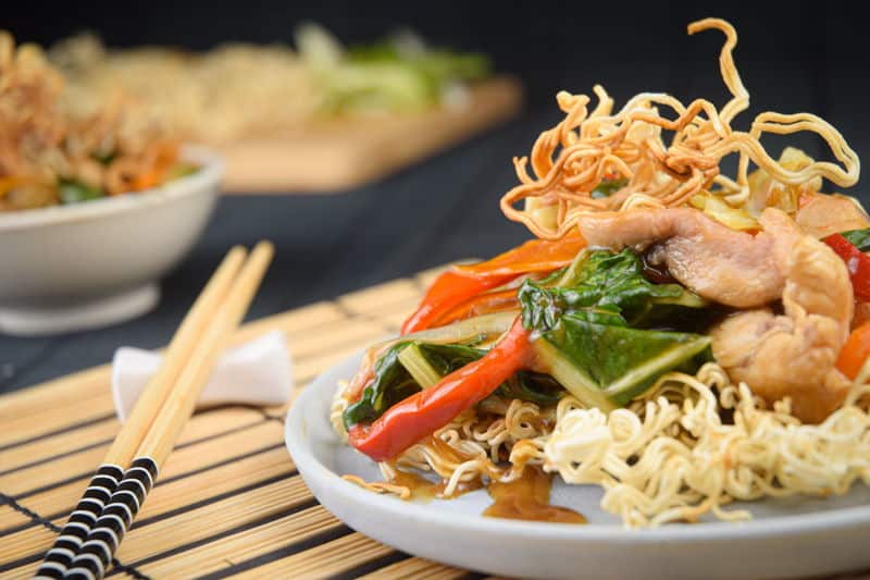 Crunchy chow mein noodles with chopsticks.